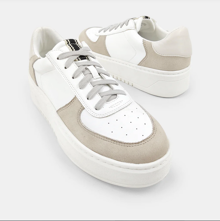 Top view of a white and taupe shoe with a platform sole and laces.