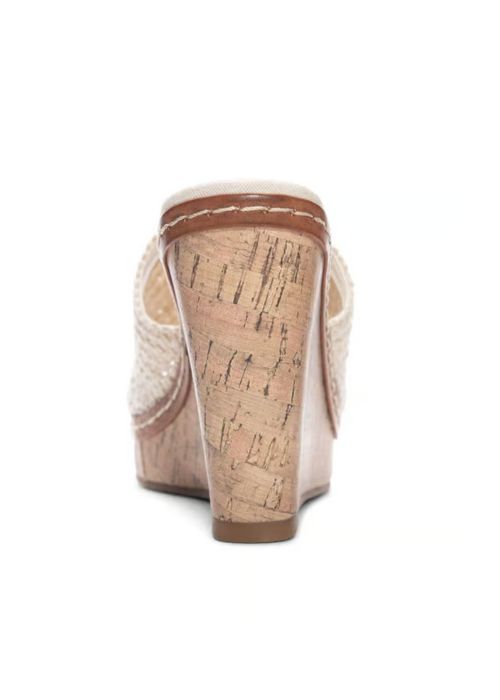 Back view of a slide on heel with a cream woven vamp on a wedge cork heel.