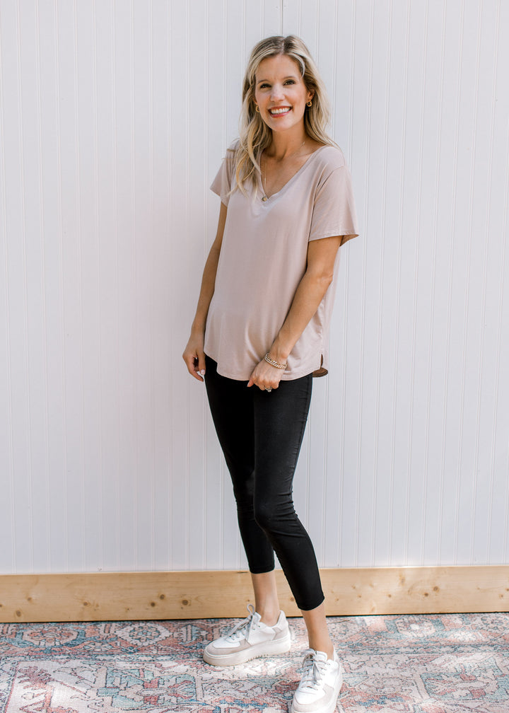 Model wearing black cropped leggings with an elastic waistband and ultra soft material.