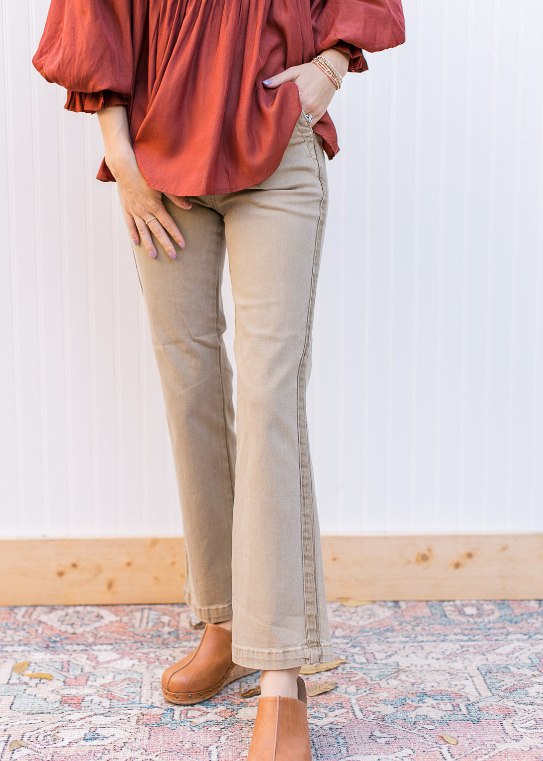 Model wearing high rise straight leg khakis with side hem detail and cropped cut.