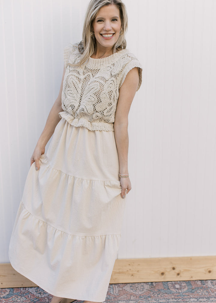 Model wearing a taupe maxi with a lined openwork crochet top and capped sleeves.