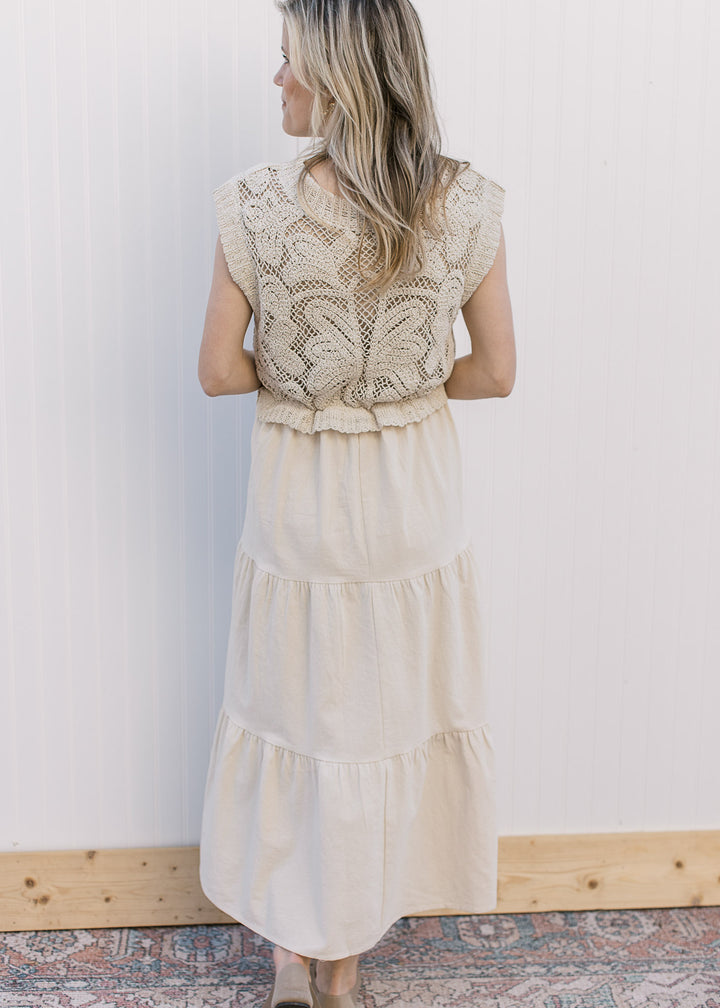 Back view of Model wearing a taupe maxi with a lined crochet top and capped sleeves.