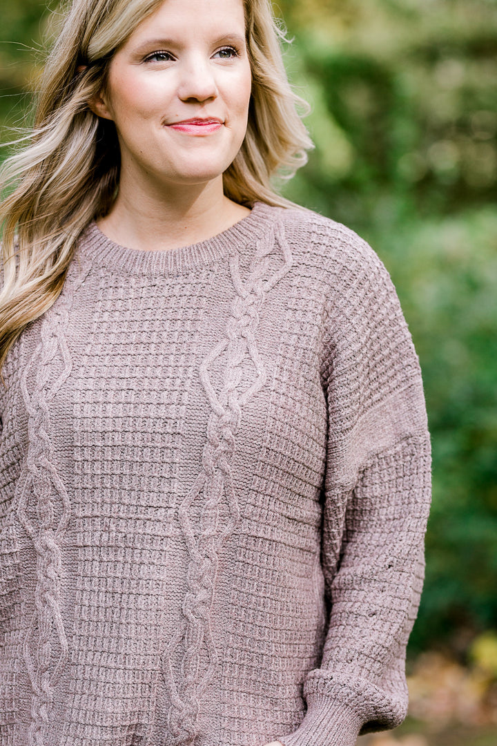 Blonde model wearing taupe sweater.