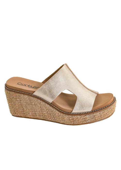 Outside view of slip on wedges with a gold metallic upper, open toe design and cushioned foot.