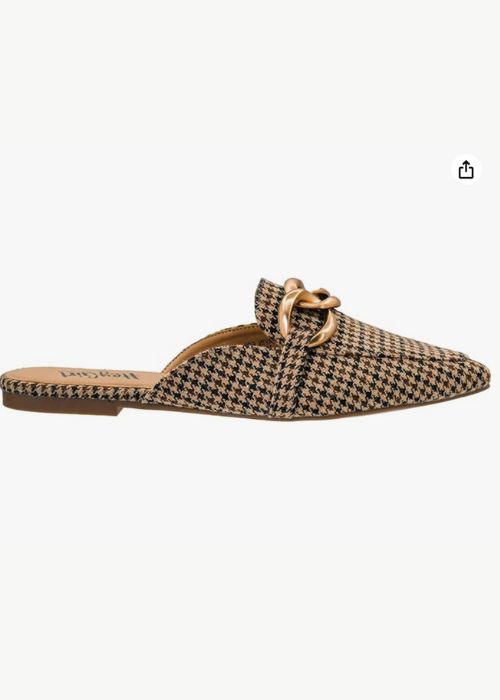 Outside view of a black and tan houndstooth shoe with a pointed-toe and gold chain embellishment. 