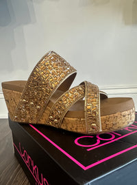 Outside view of cork wedge shoes with gold bead upper, cushioned footbed and 3 inch heel.