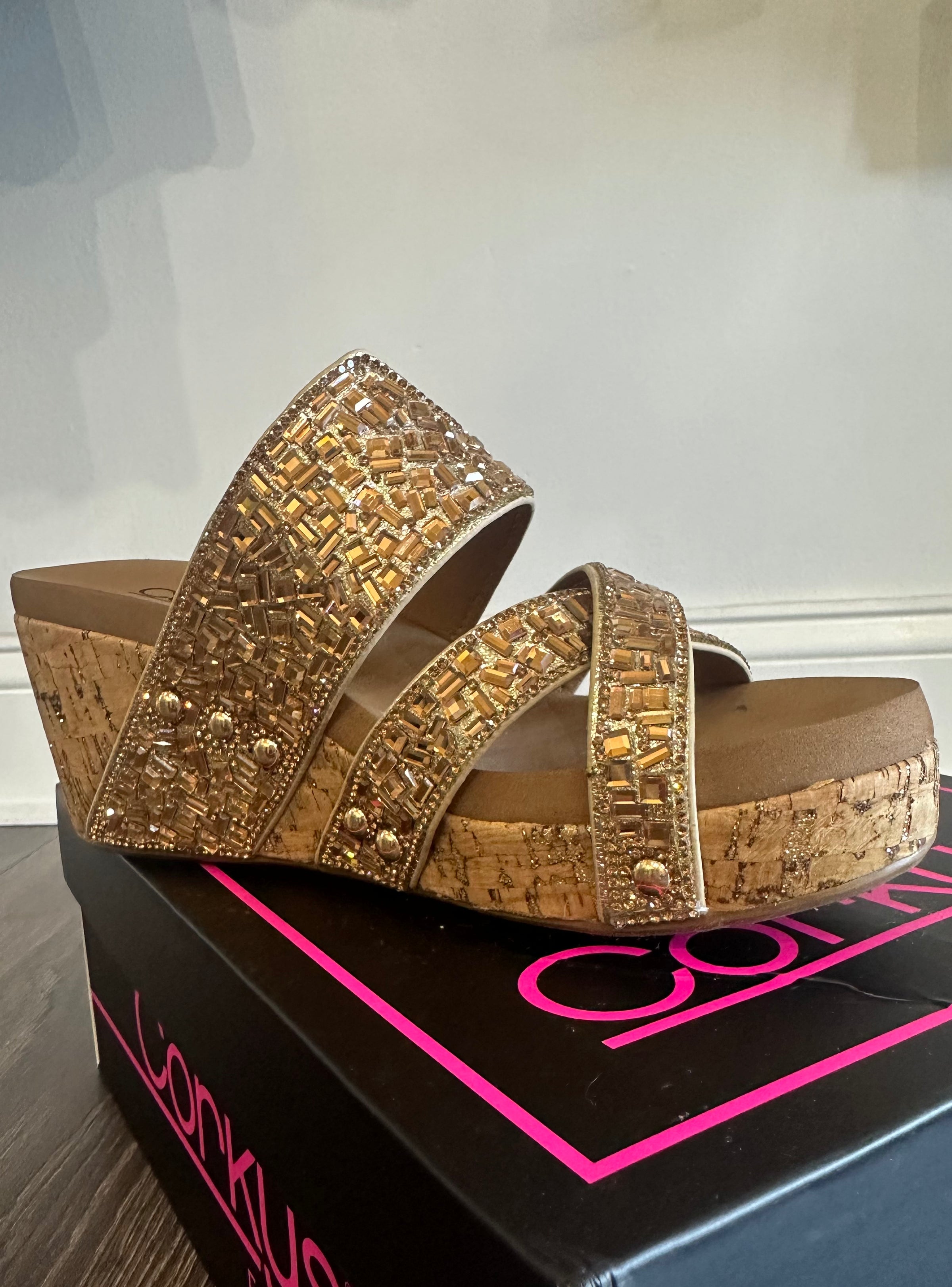 Outside view of cork wedge shoes with gold bead upper, cushioned footbed and 3 inch heel.