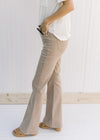 Side view of Model wearing hi-wasted, camel colored flare pants with extra tummy control. 