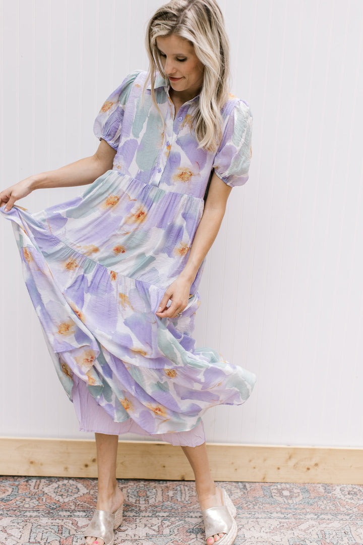 Model wearing wedges with a cream dress with watercolor flowers, tiers and bubble short sleeves. 