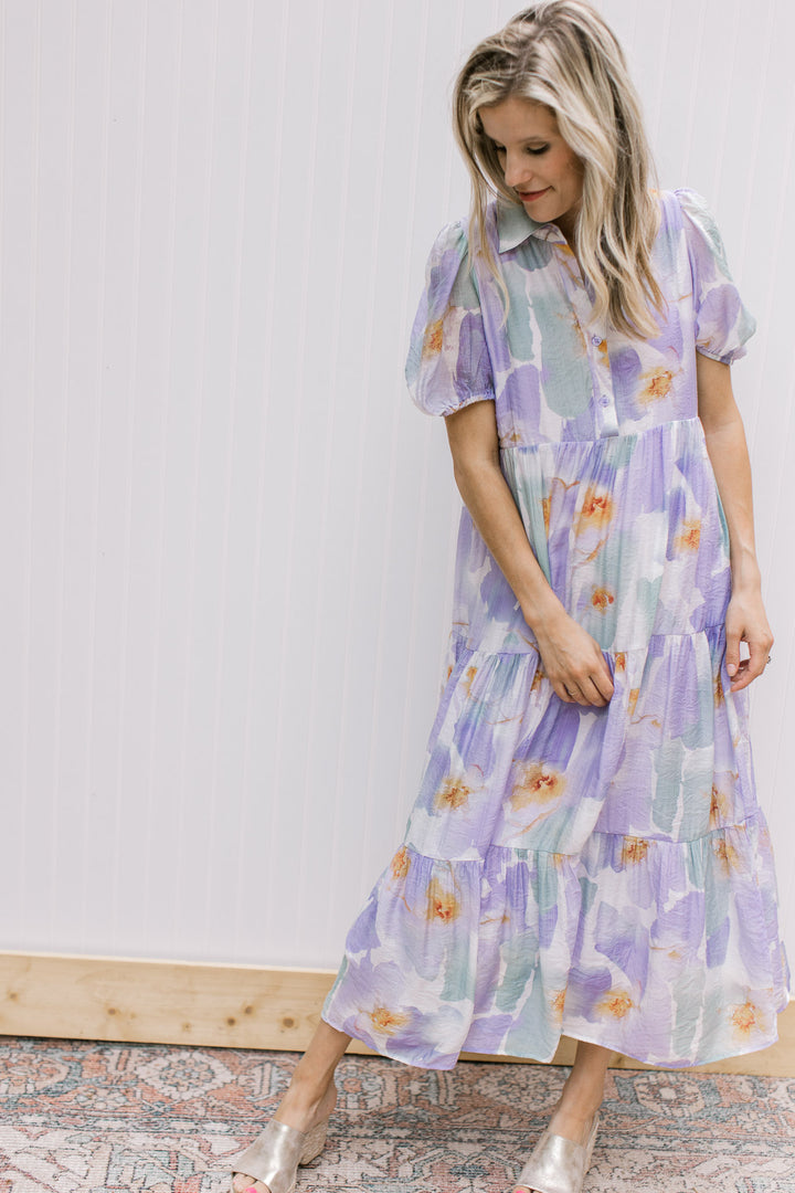 Model wearing a cream mid with watercolor flowers, collar and button front. 