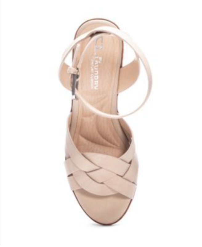 Top view of a sand color wedge sandal with a round toe, buckle closure and woven detail.
