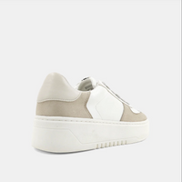 Back view of a white and taupe shoe with a platform sole and laces. 