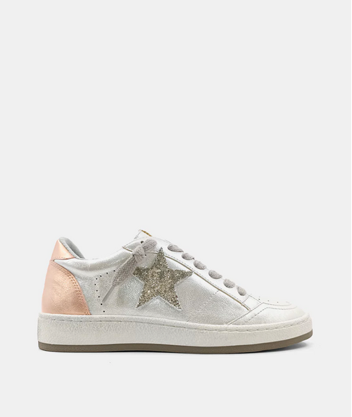 Side view of a retro sneaker with a pearly faux leather, silver glitter star and short knot lace. 