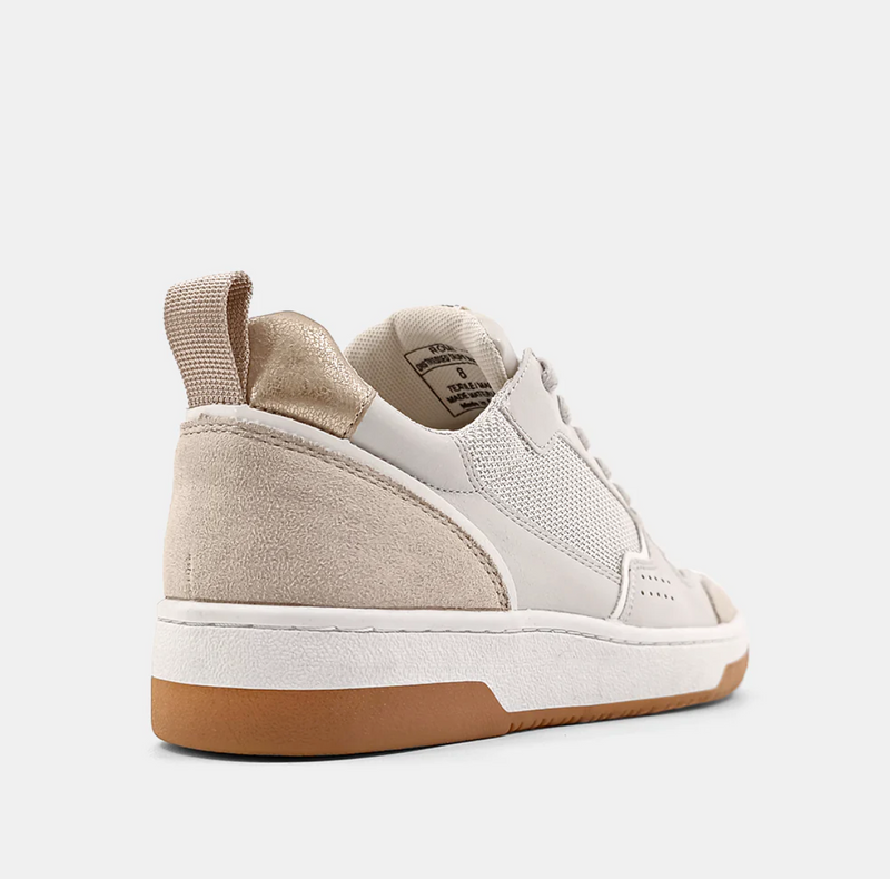 Back/outside view of a cream sneaker with a taupe upper, brown sole and mesh detail.  