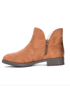 Inside view of a tan bootie lined with faux fur, having a side zip and a 3.5 inch shaft. 