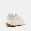 Back/outside view of cream sneakers made of faux leather and a topstitch trim.