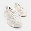 Chunky cream sneakers comprised of a faux leather with a paneled construction and a topstitch trim. 