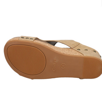 Bottom view of faux leather wedge sandals with sling back adjustable strap and a cushioned footbed.