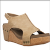 Front view of faux leather wedge sandals with sling back adjustable strap and a cushioned footbed.