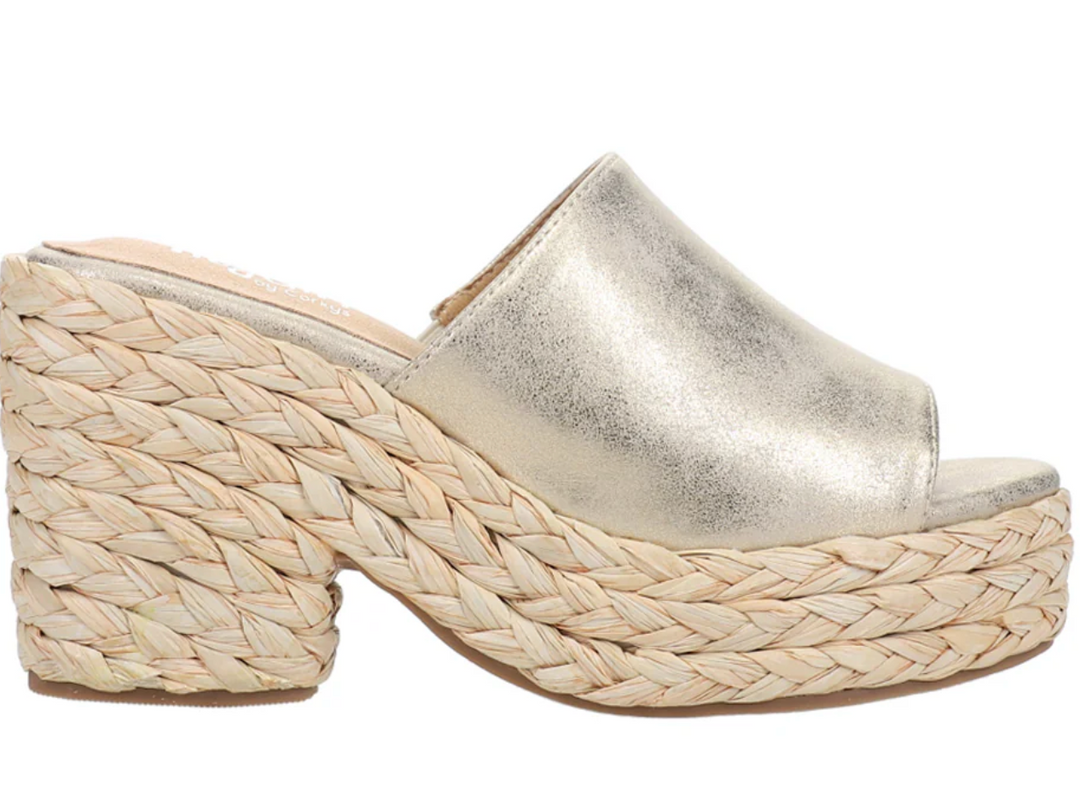 Side view of a muted gold upper on a wedge rope heel with a padded foot pad. 
