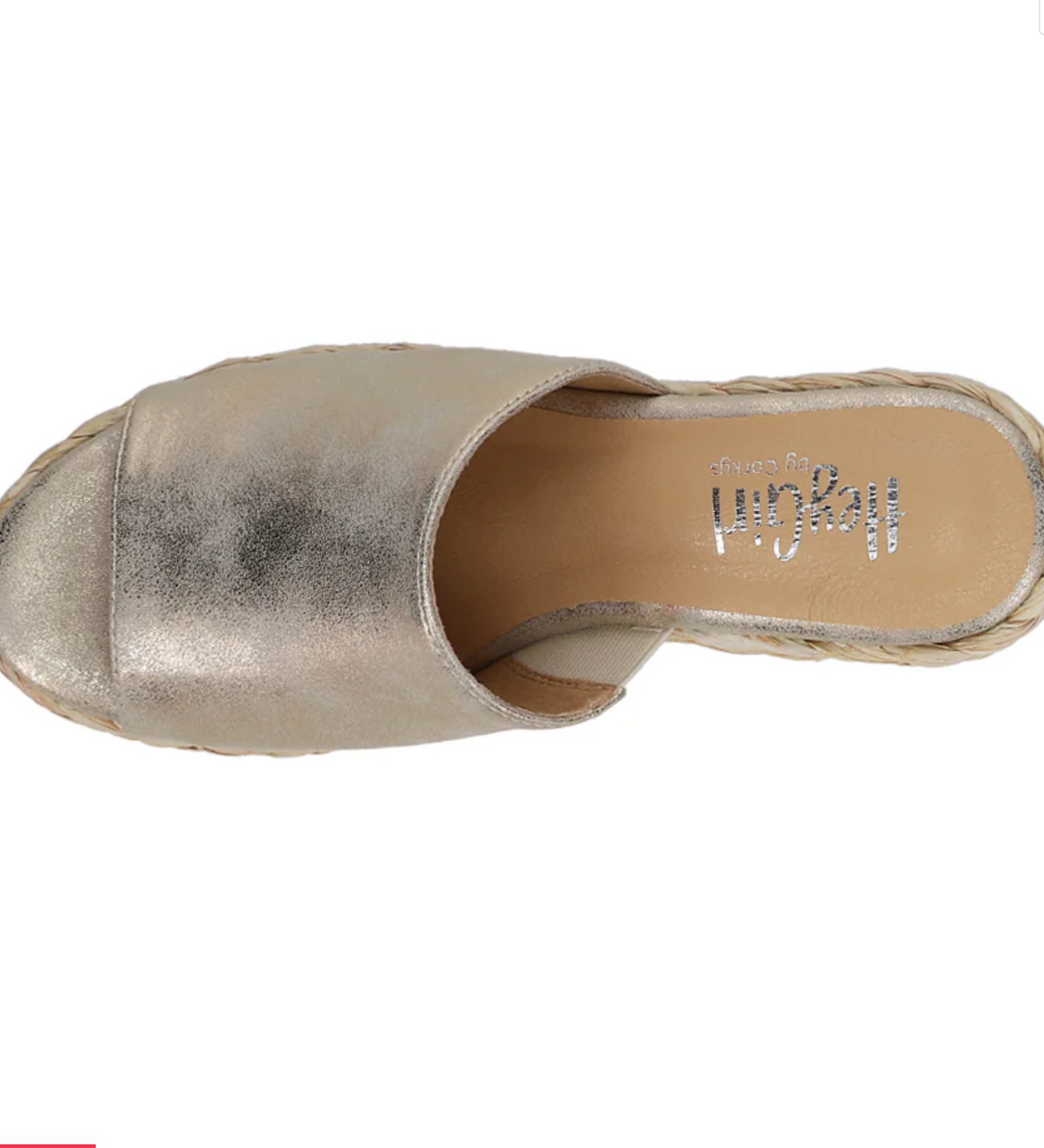 Top view of a muted gold upper on a wedge rope heel with a padded foot pad.