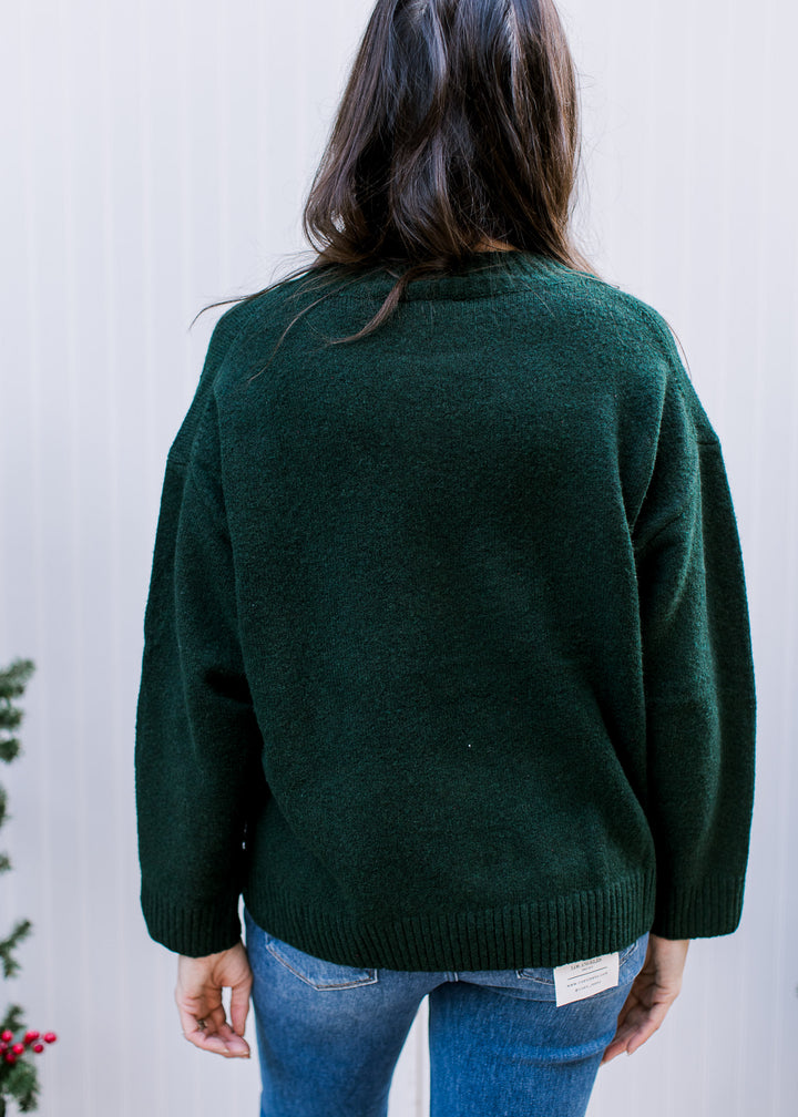 Back view of hunter green Skiing Bear Sweater with plain knit, dropped shoulders, long sleeves and ribbed hem.