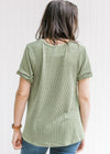 Back view of Model wearing a green corded v-neck top with cuffed short sleeves. 