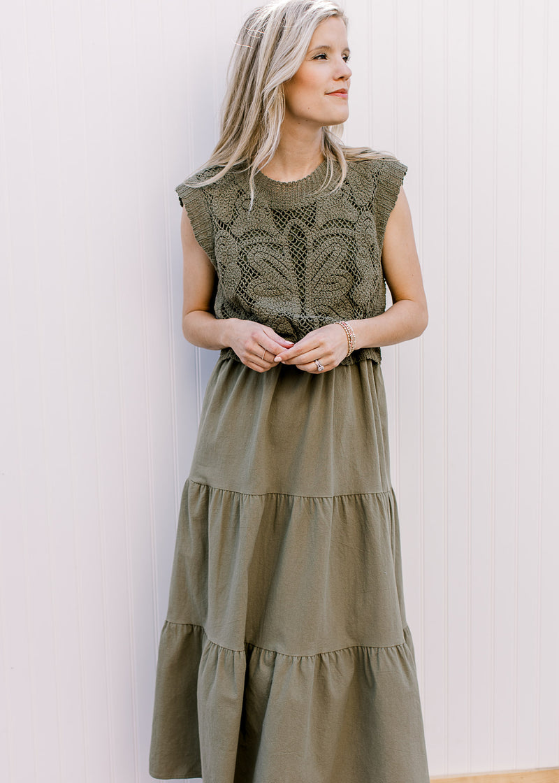 Model wearing a deep olive colored midi with lined openwork crochet top and capped sleeves. 