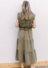 Back view of Model wearing a deep olive colored midi with openwork crochet top and capped sleeves. 