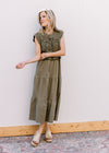 Model wearing sandals and an olive colored midi with openwork crochet top and capped sleeves. 