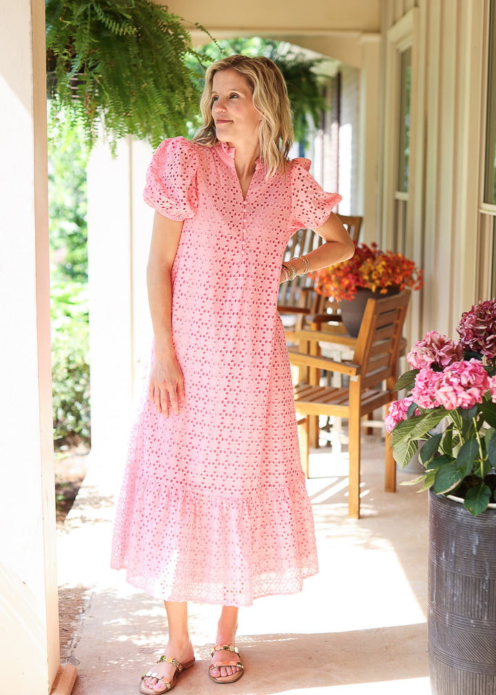 Model wearing sandals and a pink midi with eyelet detail, short bubble sleeves and v-neck.