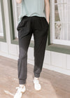 Model wearing black, ultra soft joggers with patch front pockets and elastic high waist.