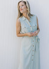 Model wearing a sleeveless, soft basil maxi with button front and patch front pockets. 