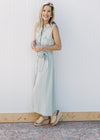Model wearing a sleeveless, soft basil maxi with button front and a tie at the waist. 