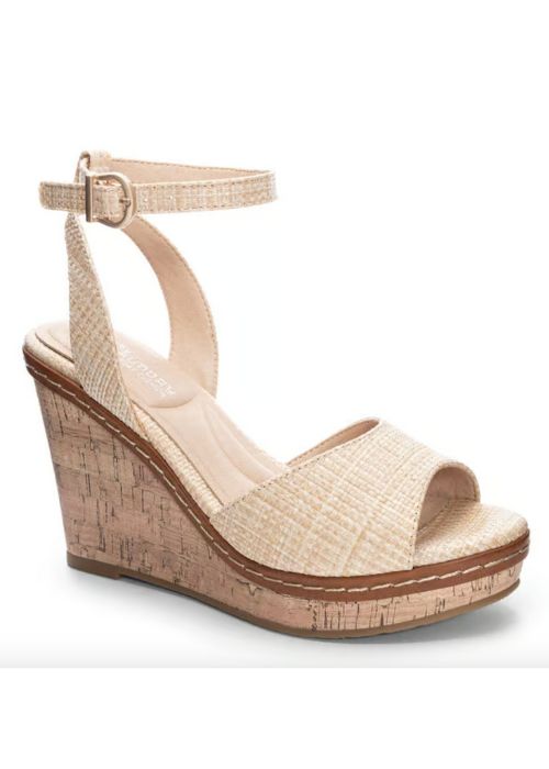 Outside view of tan heels with a padded footbed, delicate ankle strap, curved vamp, and wedge sole