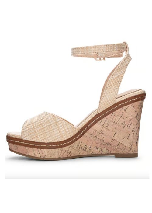 Inside view of tan heels with a padded footbed, delicate ankle strap, curved vamp, and wedge sole