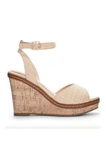 Side view of tan heels with a padded footbed, delicate ankle strap, curved vamp, and wedge sole