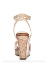 Back view of tan heels with a padded footbed, delicate ankle strap, curved vamp, and wedge sole