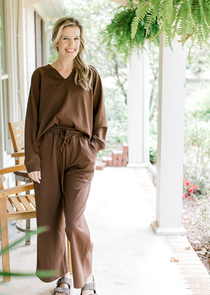 Model wearing a mocha colored set, top has a v-neck with wide leg bottoms. 