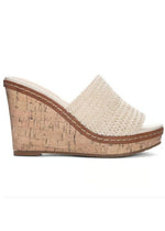 Outside view of a slide on heel with a cream woven vamp on a wedge cork heel.
