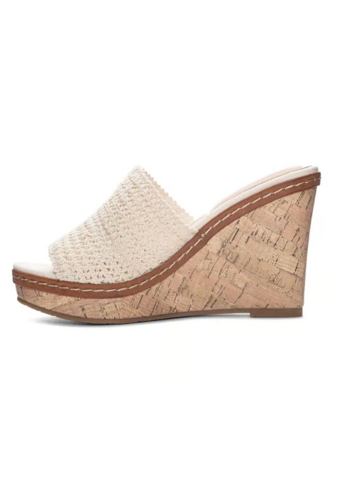 Inside view of a slide on heel with a cream woven vamp on a wedge cork heel.