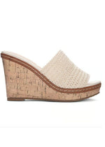 Side view of a slide on heel with a cream woven vamp on a wedge cork heel.