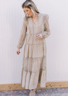 Model wearing a beige maxi with a flower mesh detail, v-neck with a tie and mesh bubble sleeves.