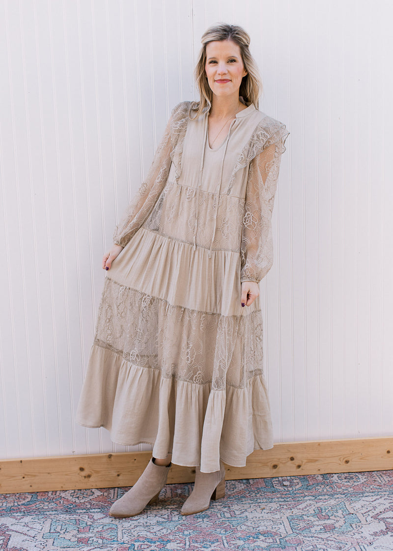 Model wearing booties and a beige maxi with a flower mesh detail, v-neck and mesh bubble sleeves.