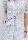 Close up of tie belt at the waist of a cream midi with pale blue floral and a button front. 