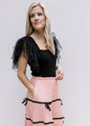 Model wearing a pink skirt with a  black bodysuit with a square neck and mesh ruffle sleeves.
