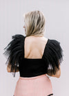Back view of Model wearing a black bodysuit with a square neck and mesh ruffle sleeves.