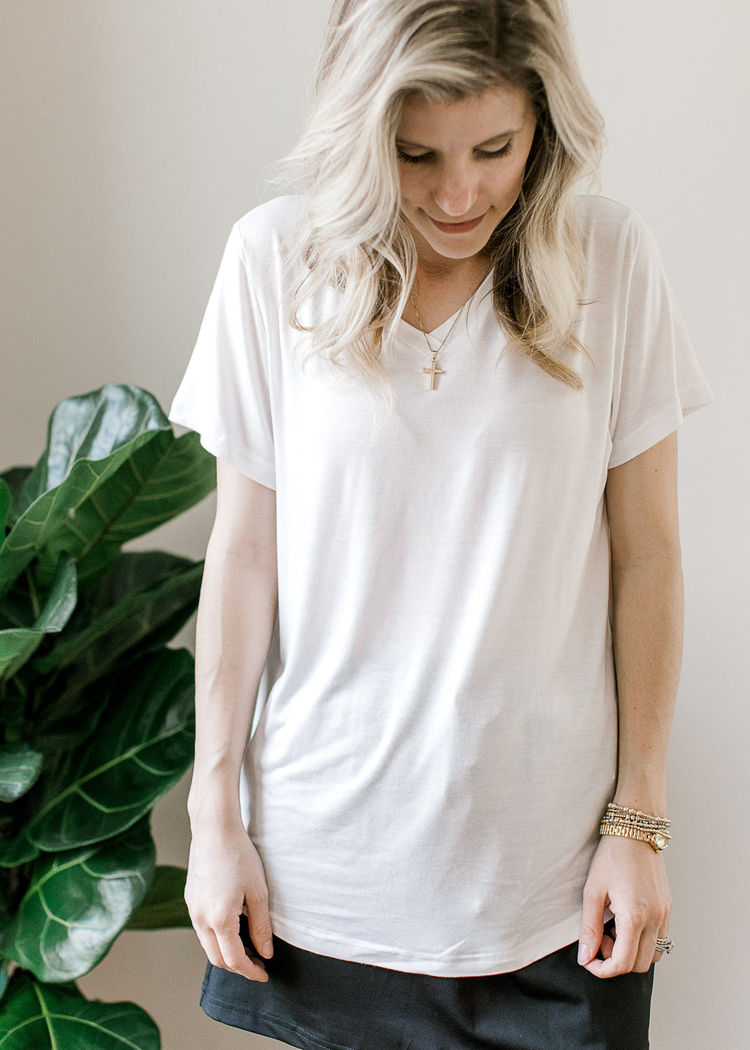 Model wearing a white top with a black skort with an elastic waist with tie and pockets.