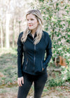 Model wearing a ribbed black jacket with a  front zip,  zip pockets and long sleeves.