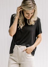Model wearing khakis with a black cropped top with short sleeves and a bamboo viscose material.
